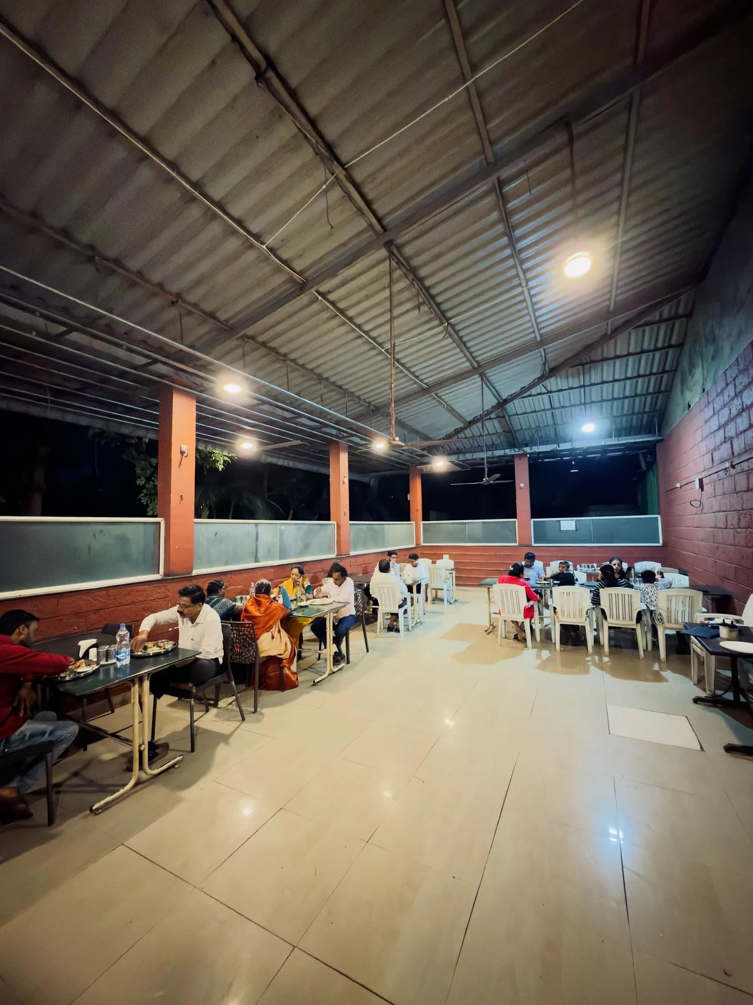 Wide view of the busy dining hall at Hotel Atithi
