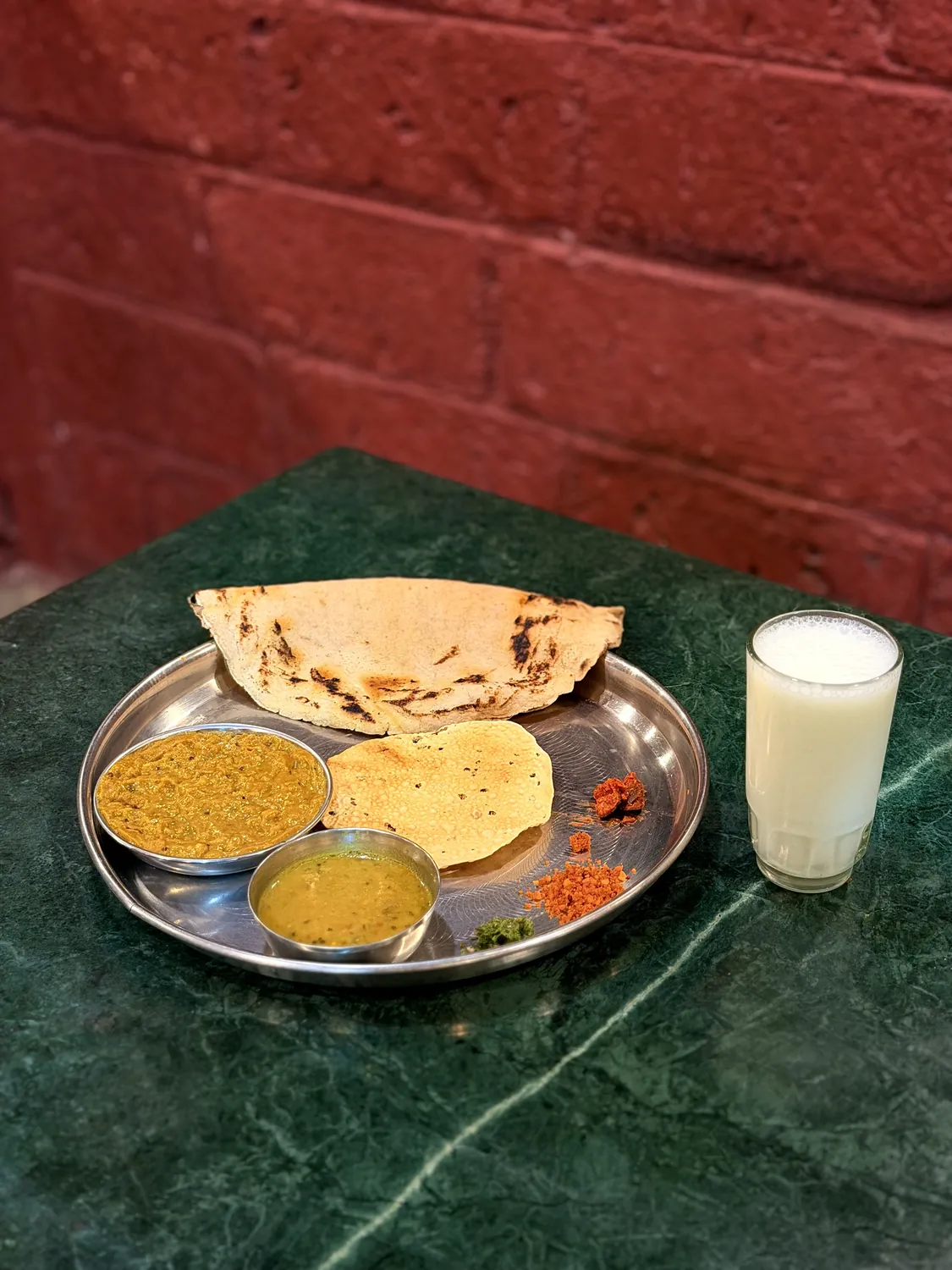 Bhakri, papad, dal and a glass of taak