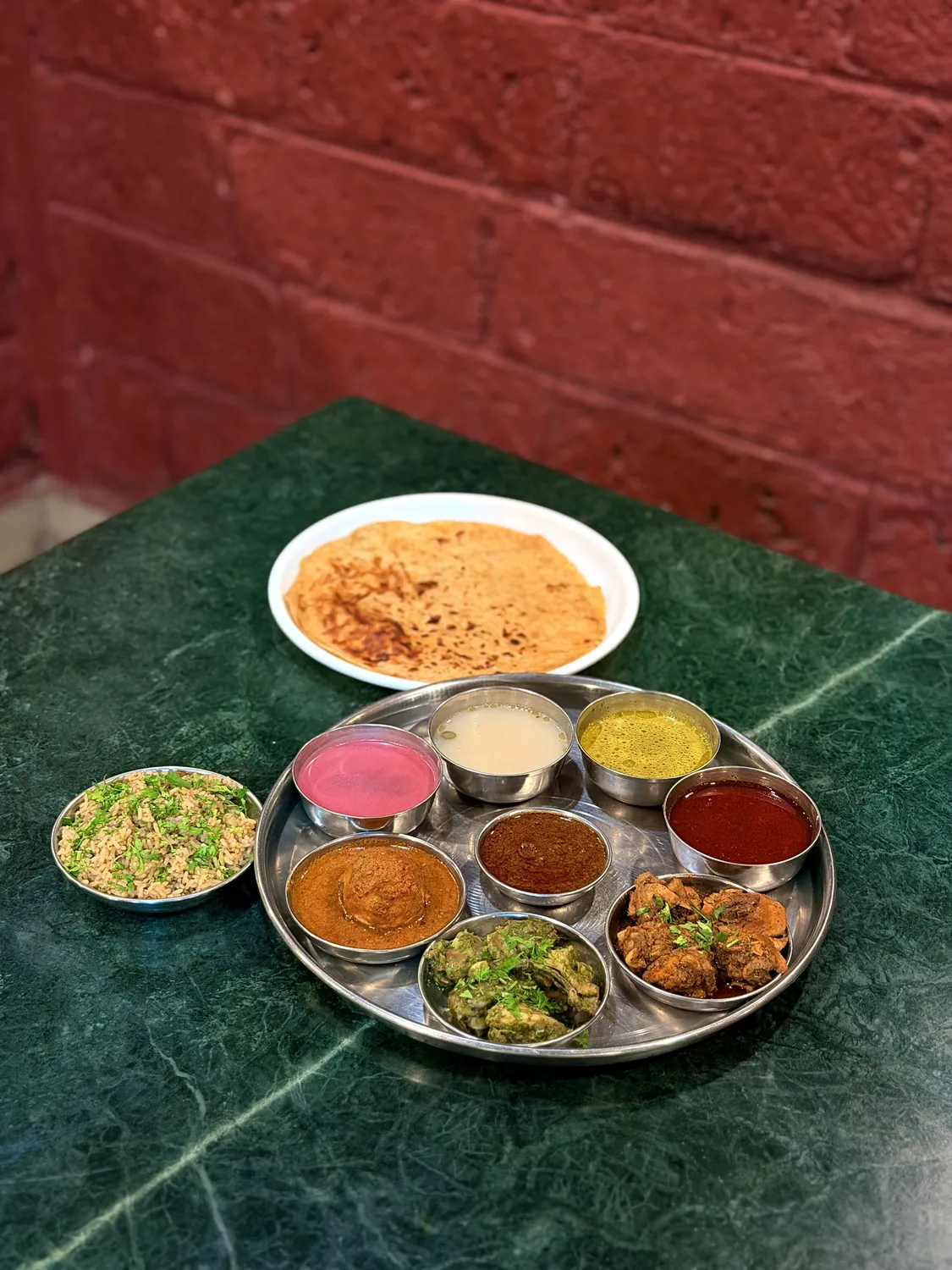 Chicken thali with rice, curries and papad