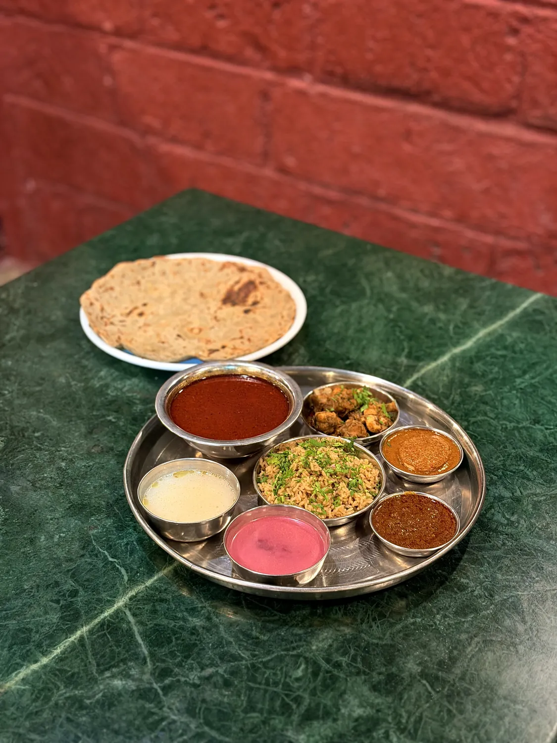 Mutton thali with a large bowl of tambda rassa