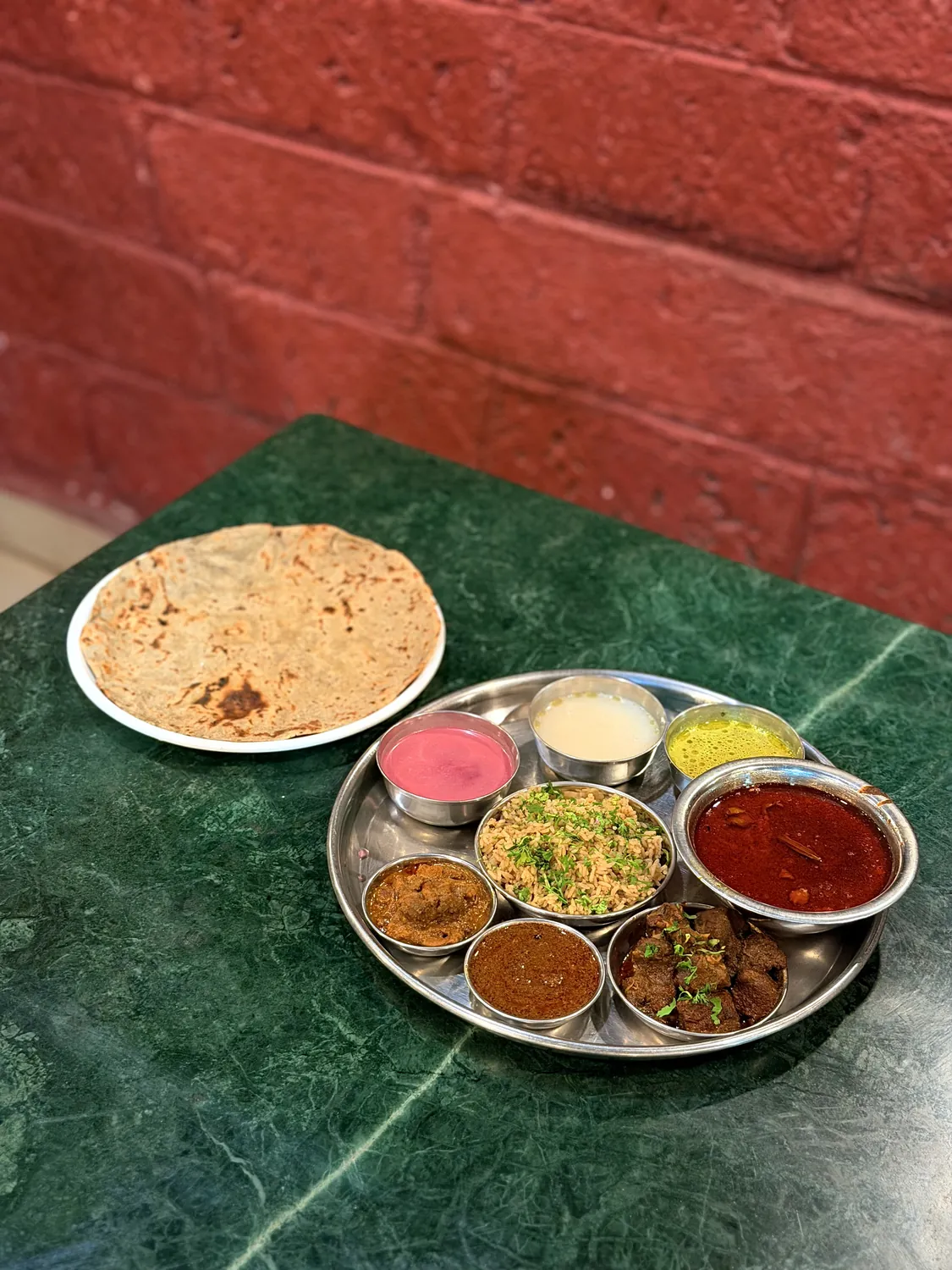 Mutton thali with rassa, sukka, rice and bhakri