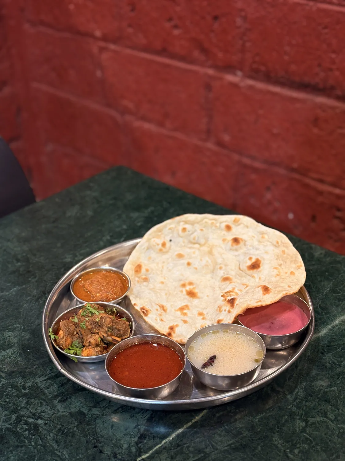 Mutton thali served with cold solkadhi and bhakri