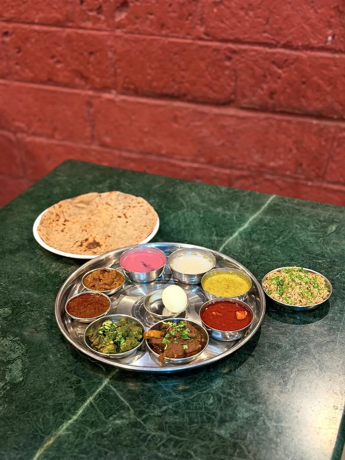 A loaded special thali with egg curry, rice and bhakri