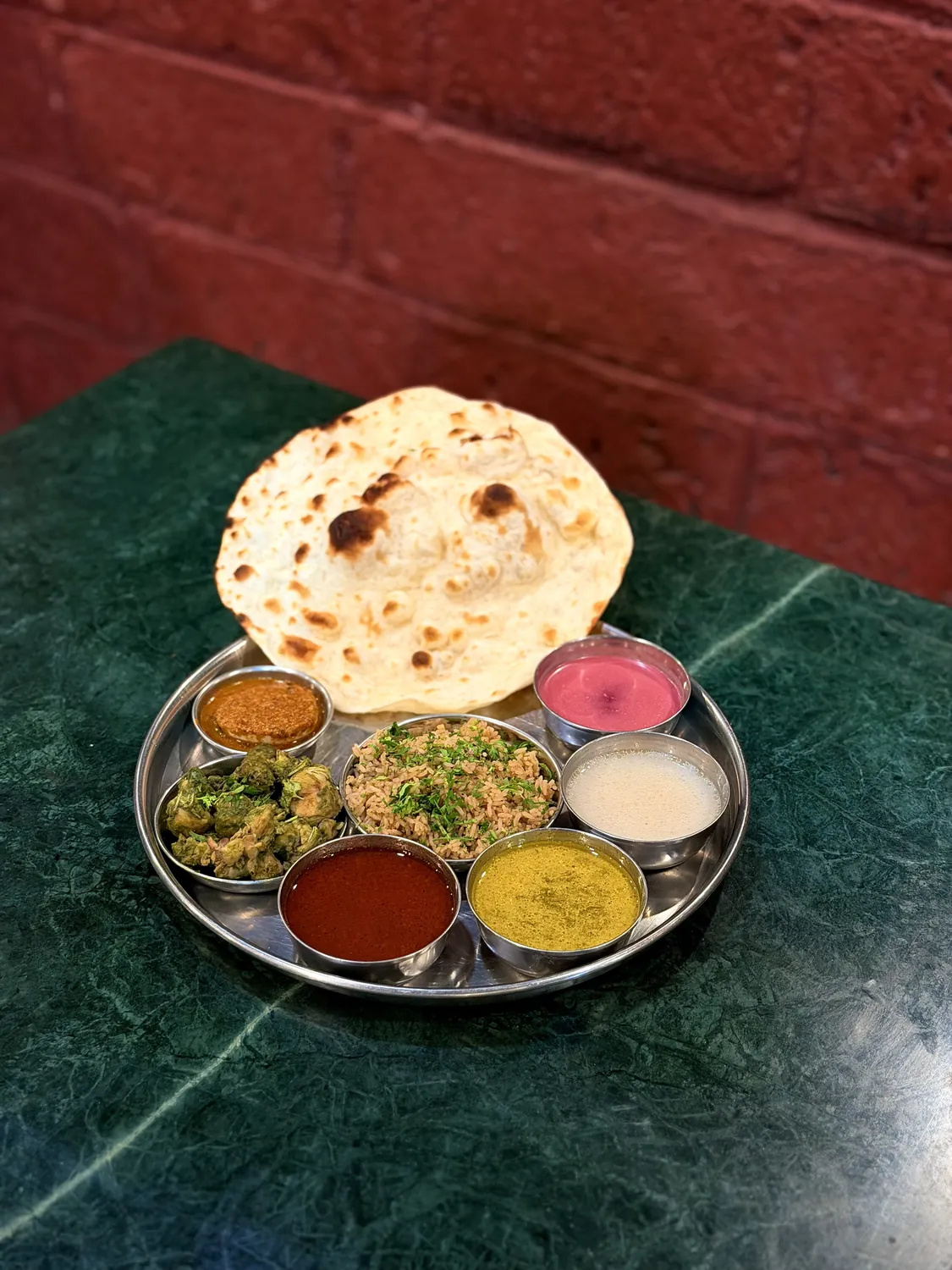 Vegetarian thali with fresh green vegetables and dal