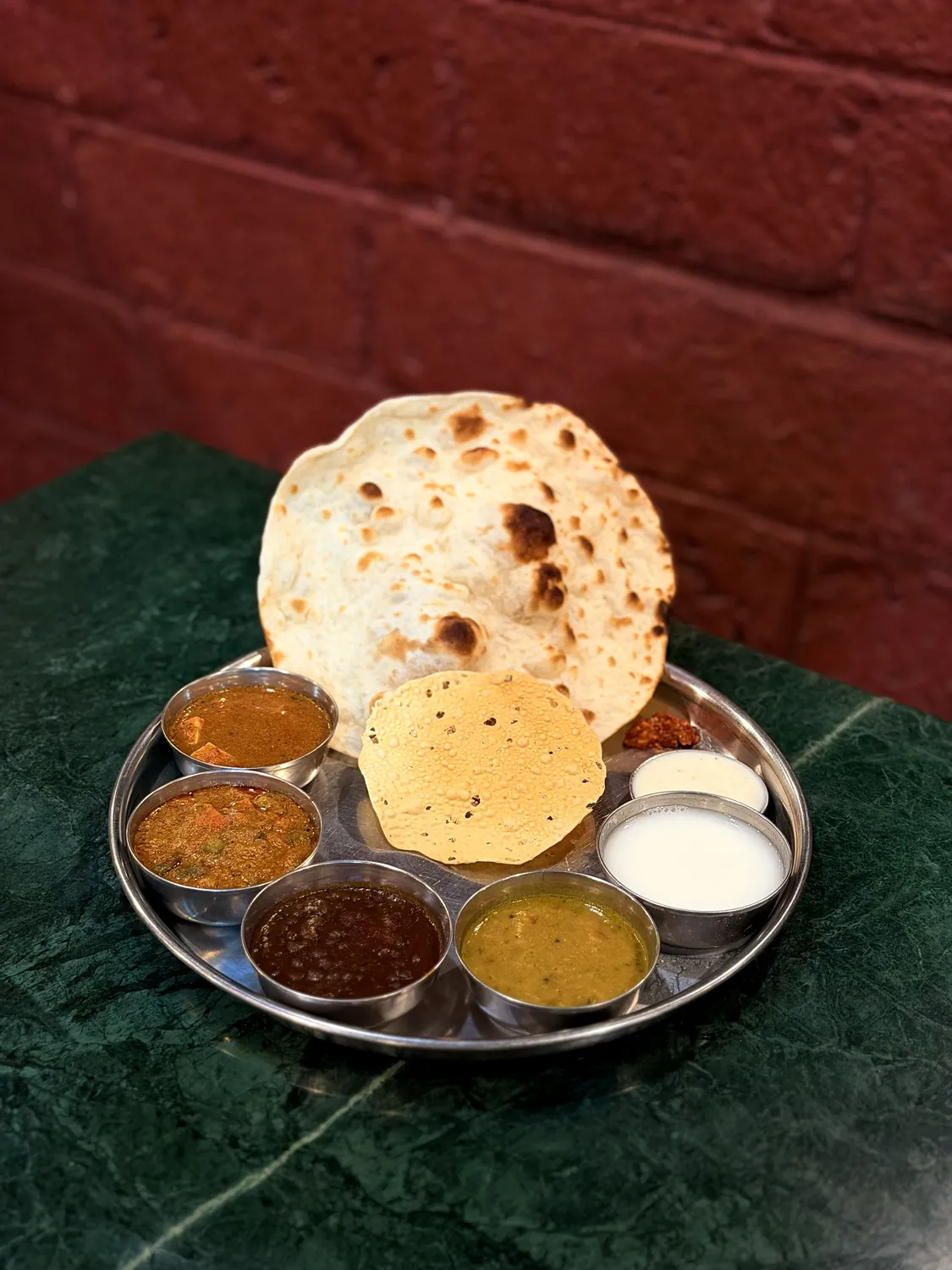 Vegetarian thali with papad, chapati and curries